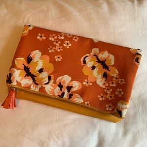 Floral fold over clutch with tassel detail